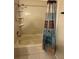 Clean bathroom with shower-tub combo, tiled walls, and practical shower curtain at 5323 Alcom Dr, Orlando, FL 32812