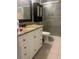 Bathroom featuring a vanity with granite countertop and glass-enclosed shower with decorative tiling at 5323 Alcom Dr, Orlando, FL 32812