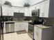 Modern kitchen with granite countertops, stainless steel appliances, and ample cabinet space at 5323 Alcom Dr, Orlando, FL 32812