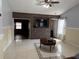 Bright and airy living room with tile floors, a ceiling fan and a decorative accent wall at 5323 Alcom Dr, Orlando, FL 32812