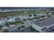 An aerial view showing a neighborhood with uniform houses, green lawns and landscaping, next to a green golf course at 561 Pebble Beach Dr, Davenport, FL 33896