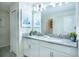 Bright bathroom featuring double sinks, a large mirror, and stylish decor, designed for comfort and convenience at 561 Pebble Beach Dr, Davenport, FL 33896