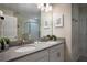 Contemporary bathroom offering double sinks, a large mirror, and neutral tones, creating a serene space at 561 Pebble Beach Dr, Davenport, FL 33896