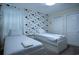 Cozy bedroom with twin beds, Mickey Mouse wallpaper, and soft lighting perfect for a retreat at 561 Pebble Beach Dr, Davenport, FL 33896