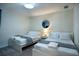 Bright bedroom offering twin beds, modern decor, and natural light, creating a comfortable and inviting space at 561 Pebble Beach Dr, Davenport, FL 33896