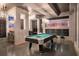 Entertainment haven boasting a stylish pool table, framed Vegas art, and textured walls for a fun ambiance at 561 Pebble Beach Dr, Davenport, FL 33896