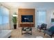Living room with designer furniture, modern decor, an accent wall and a large flatscreen TV at 561 Pebble Beach Dr, Davenport, FL 33896