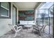 Covered patio with a cushioned sofa, chairs, and a privacy wall for outdoor relaxation and comfort at 561 Pebble Beach Dr, Davenport, FL 33896