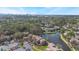 Aerial view of the community showing proximity to city, mature trees, a lake and parking at 5842 Peregrine Ave # C01, Orlando, FL 32819