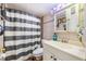 Cozy bathroom with a shower/tub combo, tiled walls, and a vanity sink at 5842 Peregrine Ave # C01, Orlando, FL 32819