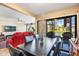 Dining area flows into a welcoming living space with tranquil views of the peaceful waterfront at 5842 Peregrine Ave # C01, Orlando, FL 32819
