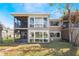 Exterior view showcasing the building's architecture with a waterfront view at 5842 Peregrine Ave # C01, Orlando, FL 32819