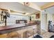 Kitchen with white cabinets, appliances, and a breakfast bar area with seating at 5842 Peregrine Ave # C01, Orlando, FL 32819
