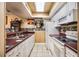 Galley kitchen with white appliances and unique decor elements at 5842 Peregrine Ave # C01, Orlando, FL 32819