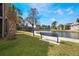 Community scene features a bench overlooking the pond with several condo units in the background at 5842 Peregrine Ave # C01, Orlando, FL 32819
