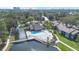 A great community pool is visible in this elevated view of the property and lake at 5842 Peregrine Ave # C01, Orlando, FL 32819