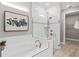 Modern bathroom features a soaking tub, glass-enclosed shower, and neutral tiling at 6319 Dew Drop Loop, St Cloud, FL 34771