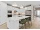 Modern kitchen with white cabinets, stainless steel appliances, a large island, and ample counter space at 6319 Dew Drop Loop, St Cloud, FL 34771