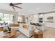 Open concept living room with a modern kitchen, breakfast bar, and a connected dining area at 6319 Dew Drop Loop, St Cloud, FL 34771