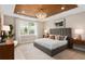 Stylish main bedroom with a wood-paneled ceiling, a chandelier, and a large window at 6319 Dew Drop Loop, St Cloud, FL 34771