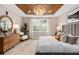 A well-lit main bedroom showcasing modern furnishings, a patterned ceiling, and natural light at 6319 Dew Drop Loop, St Cloud, FL 34771