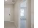 Hallway with ceramic tile entry, leading to a bedroom with plush carpeting at 6634 Lullaby Way, Mascotte, FL 34753