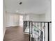 Second floor hallway featuring iron railing and views to the first floor and various rooms at 8722 Hastings Beach Blvd, Orlando, FL 32829