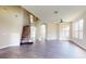 Open-concept living room featuring hardwood floors, staircase, and plenty of natural light at 8722 Hastings Beach Blvd, Orlando, FL 32829