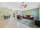 Inviting living room featuring tile floors, ceiling fan, with an adjacent dining area and pass-through to the kitchen at 9563 Chandon Dr, Orlando, FL 32825