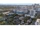 Scenic aerial shot of the cityscape featuring modern high-rise condos surrounded by lush green trees and roadways at 101 S Eola Dr # 1001, Orlando, FL 32801