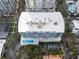 Aerial view of a modern condominium building with a rooftop pool and manicured landscaping at 101 S Eola Dr # 1001, Orlando, FL 32801