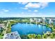 Stunning aerial view featuring a pristine lake surrounded by lush greenery and modern buildings under a clear sky at 101 S Eola Dr # 1001, Orlando, FL 32801