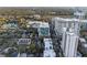 Urban living shown in an aerial view with condo buildings, single Gathering homes, roadways, and lush green trees at 101 S Eola Dr # 1001, Orlando, FL 32801