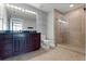 Bathroom featuring a double vanity sink and tile shower with glass doors at 101 S Eola Dr # 1001, Orlando, FL 32801