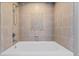 Tile-surround bathtub showcases a built-in niche for added convenience and style at 101 S Eola Dr # 1001, Orlando, FL 32801