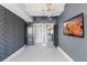 Bedroom featuring gray walls, tile floors, a mounted TV, and closet access at 101 S Eola Dr # 1001, Orlando, FL 32801