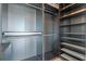 Organized walk-in closet featuring built in shelving and hanging rods at 101 S Eola Dr # 1001, Orlando, FL 32801