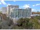 Modern condo building features glass windows and a rooftop pool providing upscale city living with luxury amenities at 101 S Eola Dr # 1001, Orlando, FL 32801