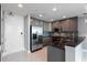 Well-lit kitchen featuring stainless steel refrigerator, granite counters, gray cabinets, and modern backsplash at 101 S Eola Dr # 1001, Orlando, FL 32801