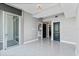 Bright living room featuring high ceilings, gray walls, and large windows and tile floors at 101 S Eola Dr # 1001, Orlando, FL 32801