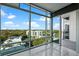 Bright living room with large windows offering a skyline view, marble floors, and access to a balcony at 101 S Eola Dr # 1001, Orlando, FL 32801