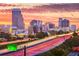 Skyline view featuring a sunrise with colorful lights reflecting along the highway at 101 S Eola Dr # 1001, Orlando, FL 32801