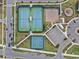 Overhead view of community tennis, pickleball and basketball courts and playground at 10426 Folly Beach Rd, Orlando, FL 32827