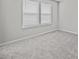 Bright bedroom with two windows, plush carpeting, and neutral color palette at 10426 Folly Beach Rd, Orlando, FL 32827