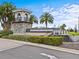 Community entrance sign with manicured landscaping, decorative stone tower and water feature at 10426 Folly Beach Rd, Orlando, FL 32827