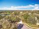 Beautiful aerial view featuring a serene lake surrounded by tree-lined properties at 1121 Magnolia Blossom Ct, Apopka, FL 32712