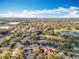 Aerial view of a community pond and golf course among homes and trees at 1121 Magnolia Blossom Ct, Apopka, FL 32712