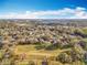 Wide aerial view of community showcasing homes and green spaces under blue skies with scattered clouds at 1121 Magnolia Blossom Ct, Apopka, FL 32712