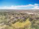 Wide aerial view of community showcasing homes and green spaces under blue skies with scattered clouds at 1121 Magnolia Blossom Ct, Apopka, FL 32712