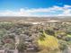 Wide aerial view of community showcasing homes and green spaces under blue skies with scattered clouds at 1121 Magnolia Blossom Ct, Apopka, FL 32712